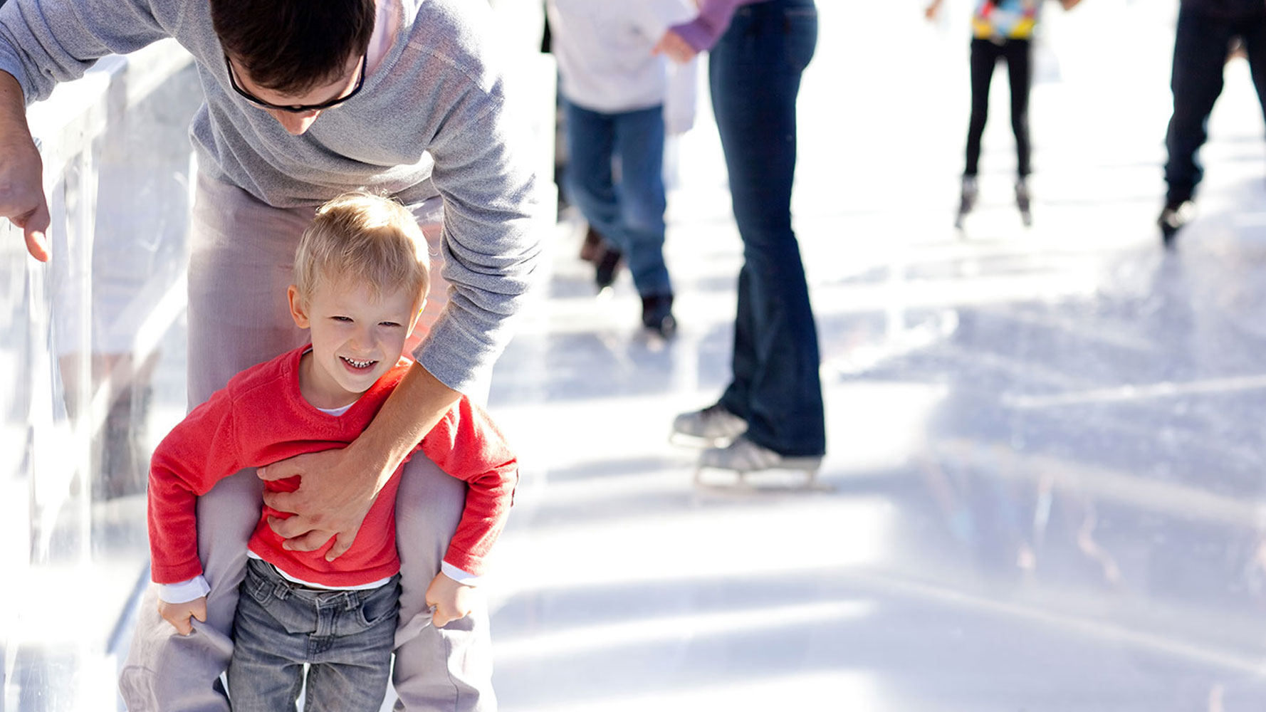 Father And Son On Skating Rink